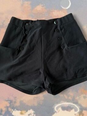 Black high-waisted shorts with button details. Size: M